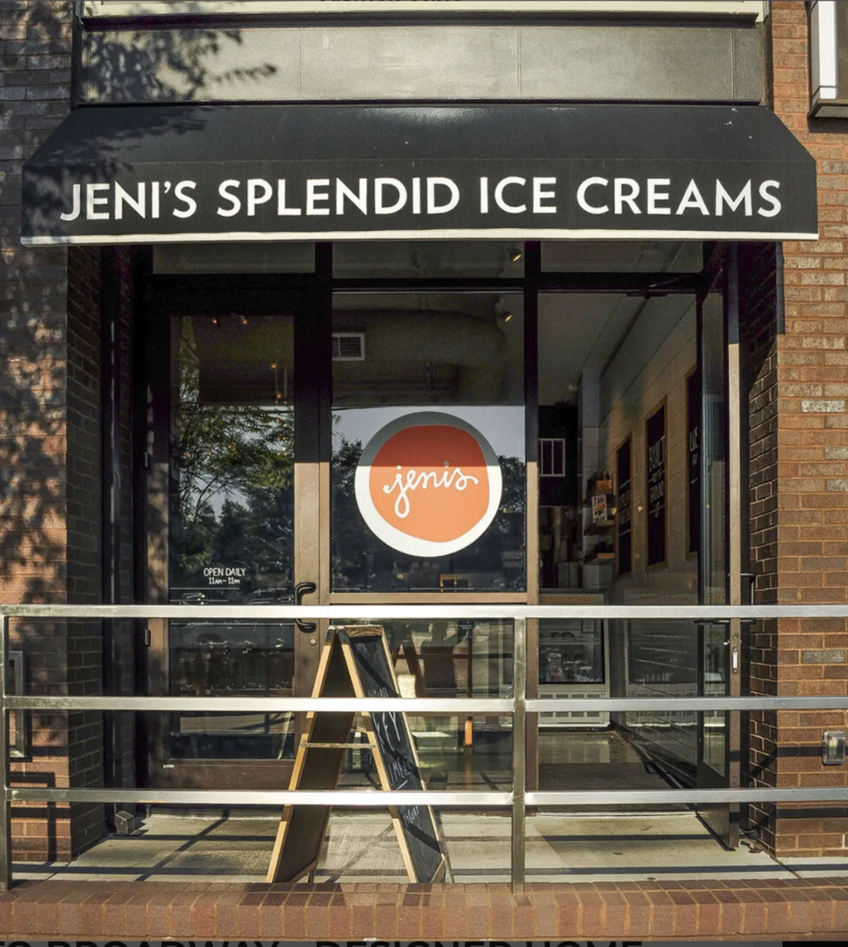 The image displays the cheerful storefront of Eskimo Joe’s Ice Cream, complete with a welcoming entrance, a visible menu board, and space for guests to gather outside. The exterior is lively, inviting, and suggests a local hangout spot for quick treats.