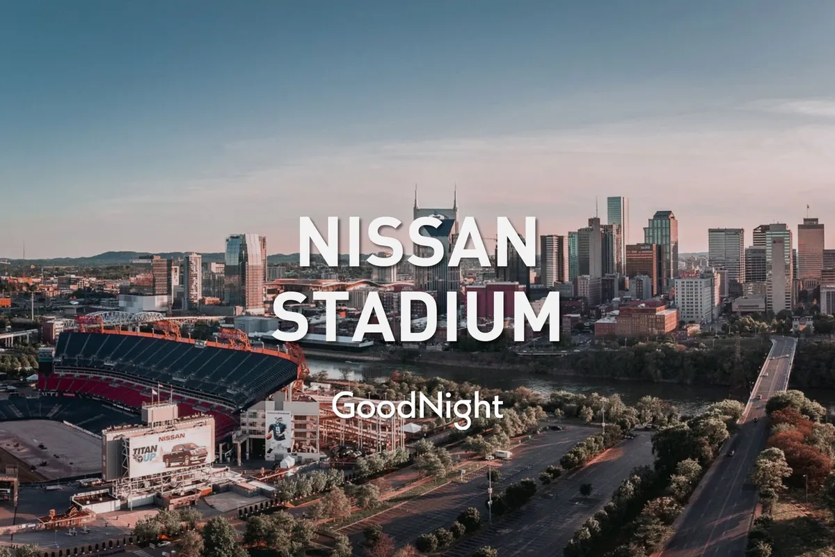 This wide view shows Nissan Stadium alongside the Nashville skyline and the river, with the stadium prominent and the city’s tall buildings rising in the background. The atmosphere is alive and dynamic, hinting at both thrilling sports events and citywide gatherings.