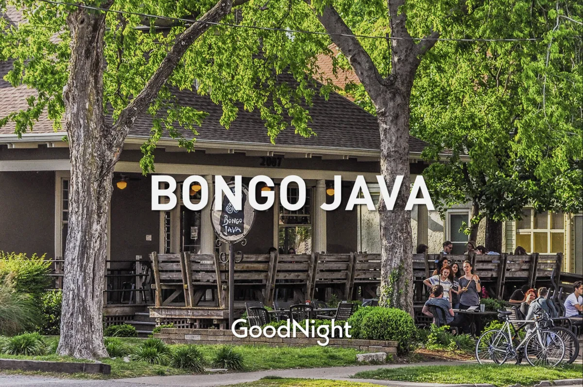 A friendly street-level scene outside Bongo Java, a beloved local coffee shop. The image features its recognizable sign and inviting outdoor seating shaded by lush tree canopies, with people socializing and enjoying the Nashville atmosphere.
